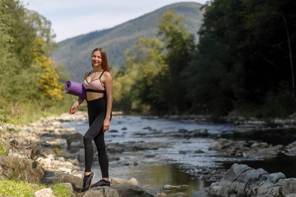 fitness-sports-yoga-healthy-lifestyle-concept-young-woman-with-slim-healthy-body-standing-with-yoga-mat (1).jpg